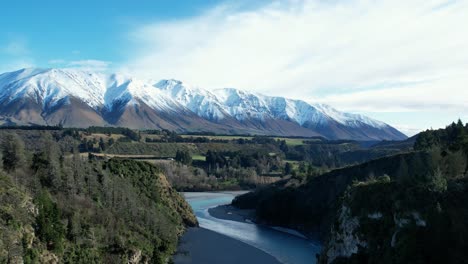 aerial ascent above beautiful rakaia river gorge - early morning, mid-winter, fresh snow on mount hutt