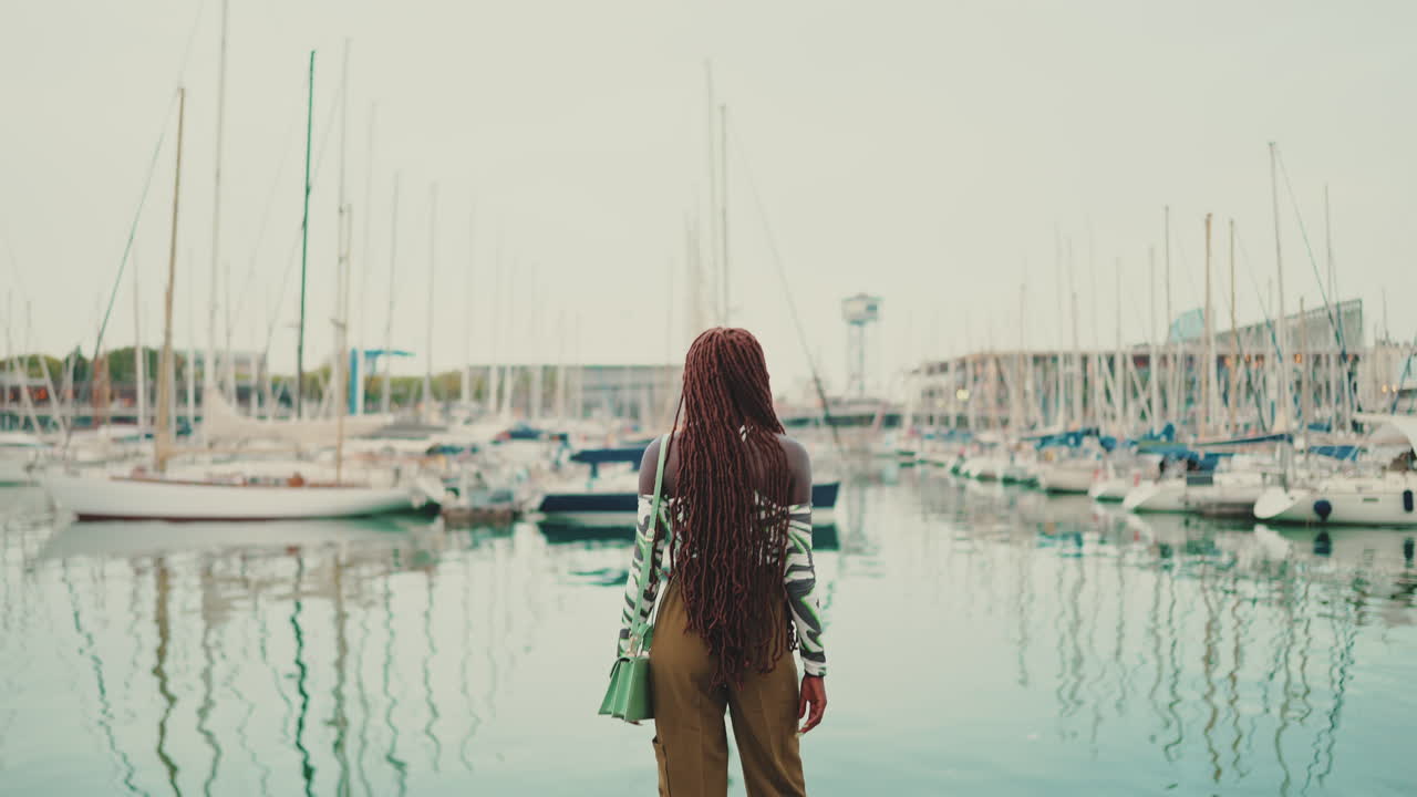 Woman in marina with boats