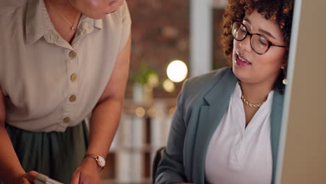 two businesswomen collaborating in an office