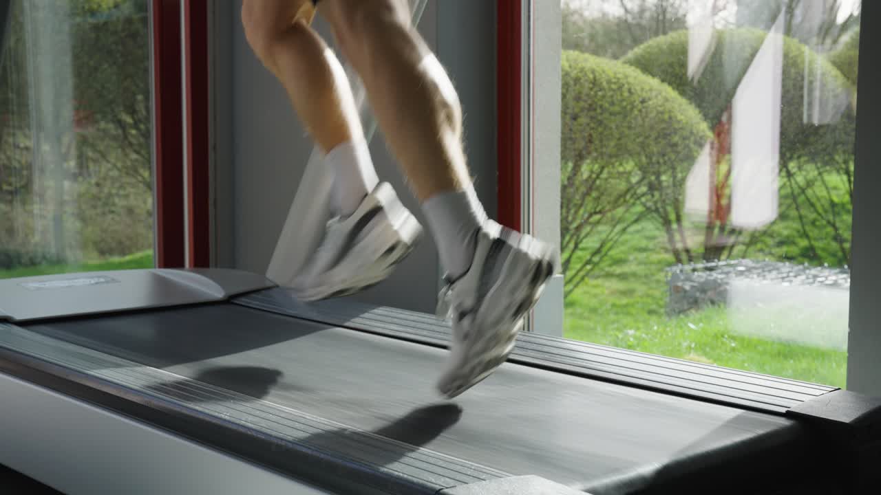 Low angle view of person do running cardio exercise on treadmill, indoor gym