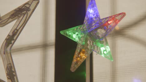 merry xmas star led light hanging in window colourful two