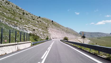 moving view (car, motorbike or bicycle) of a mountain landscape