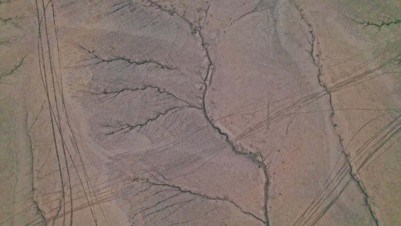 Aerial drone 4k view of scenic erosion patterns leading to Factory Butte in Utah’s desert, iconic badlands and rugged terrain
