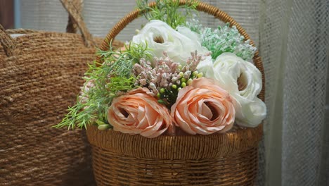 beautiful floral arrangement in a wicker basket with straw bag
