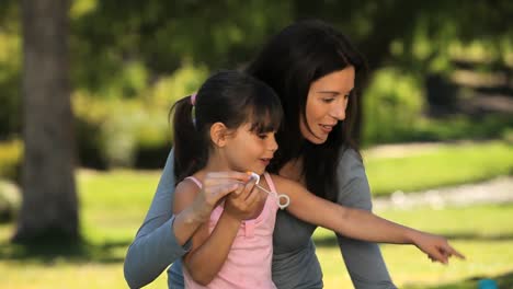 Daughter-blowing-bubbles-with-her-mother