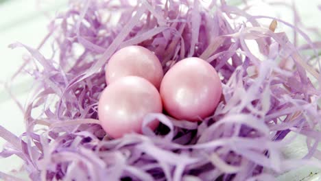 pink easter eggs in purple nest