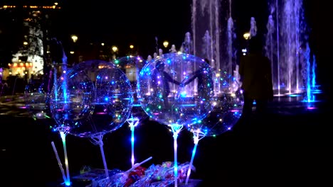 flashing electric balls on the background of the fountain in the evening