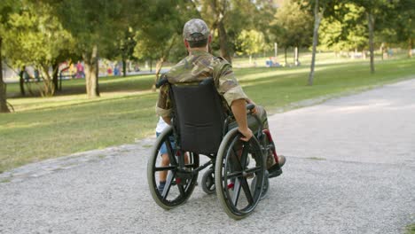 disabled soldier walking with kids in park