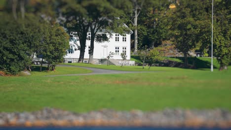 Small-tidy-white-two-storey-house-on-the-coast-of-the-fjord