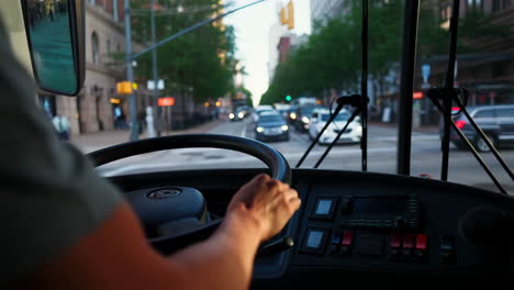 view from inside a bus driving through a city street