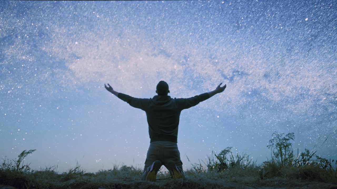 Man Kneeling in Awe of the Night Sky