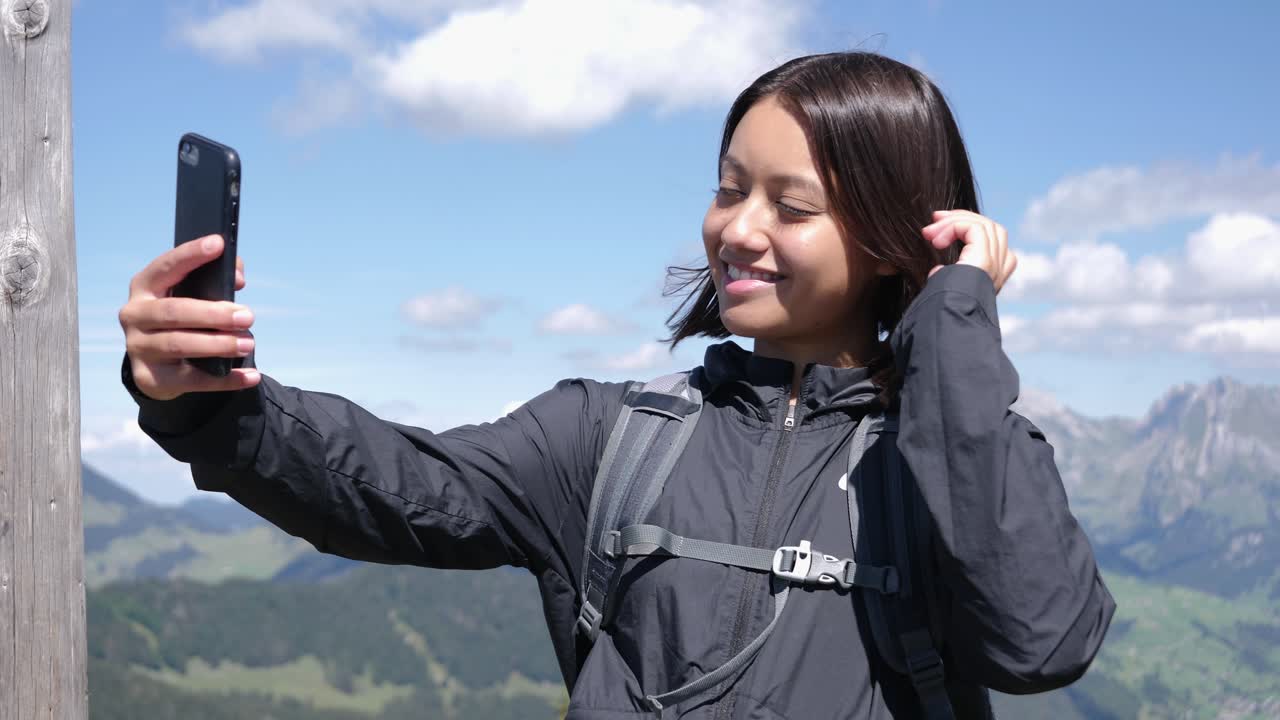 excursionista tomando selfie en vistas panorámicas de las montañas de suiza