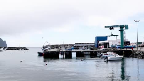 Marine-Jib-Crane-And-Floating-Boats-At-The-Harbor-In-Terceira-Island,-Portugal