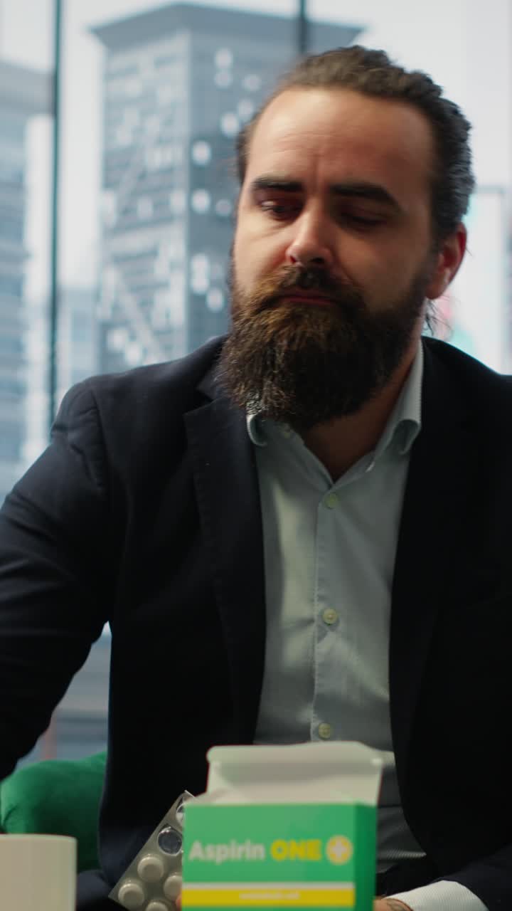 Vertical Video Concerned CEO taking an aspirin to ease the headache due to stress