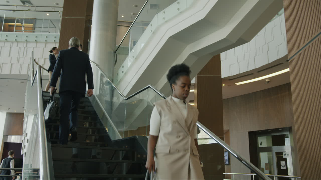Business People Climbing Stairs in Modern Office Building