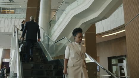 business people climbing stairs in modern office building