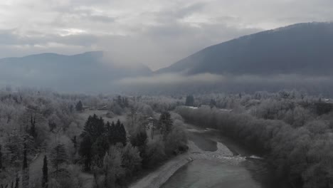 aerial view of small river and valley on frosty winter morning, gloomy cold vibes