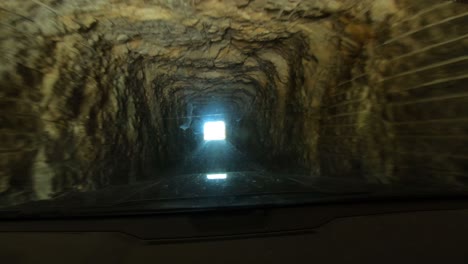 driving through short mountain tunnel pov