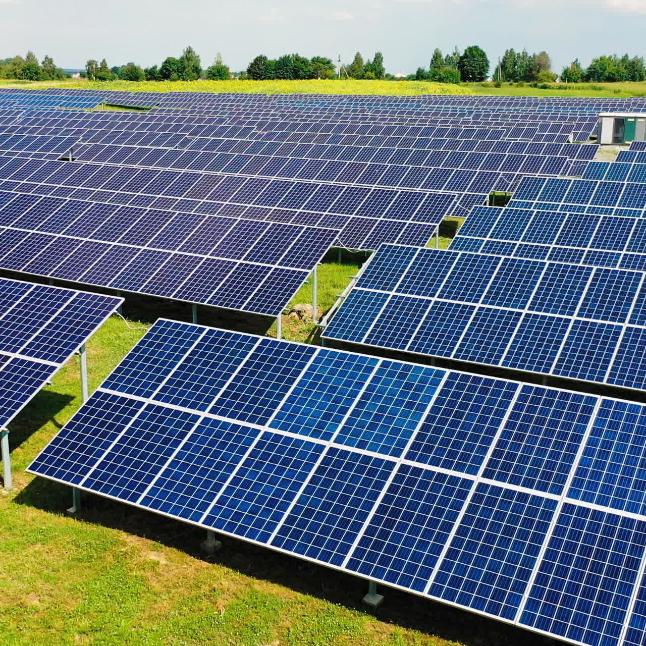 Modern power plant with many solar panels. Drone view above the rows of solar panels in the field. Alternative source of electricity.