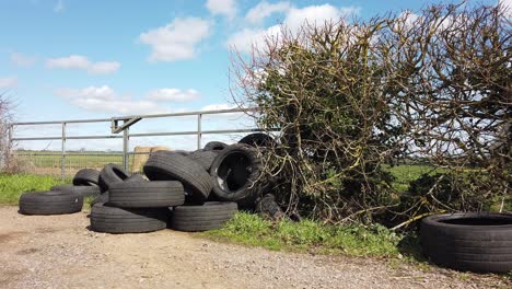 a load of tyers dumped in a gateway on a rural road in england united kingdom