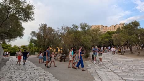 visitors walking around the parthenon in athens, greece