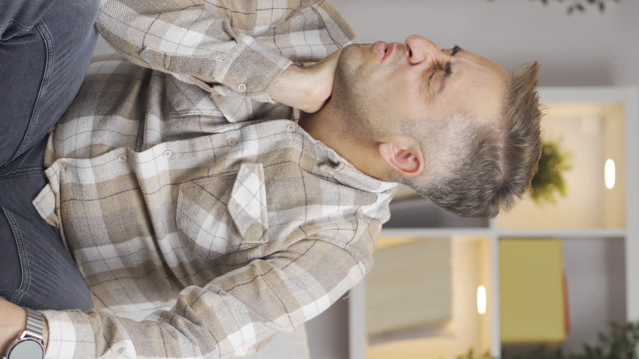 Vertical video of Man with neck pain.