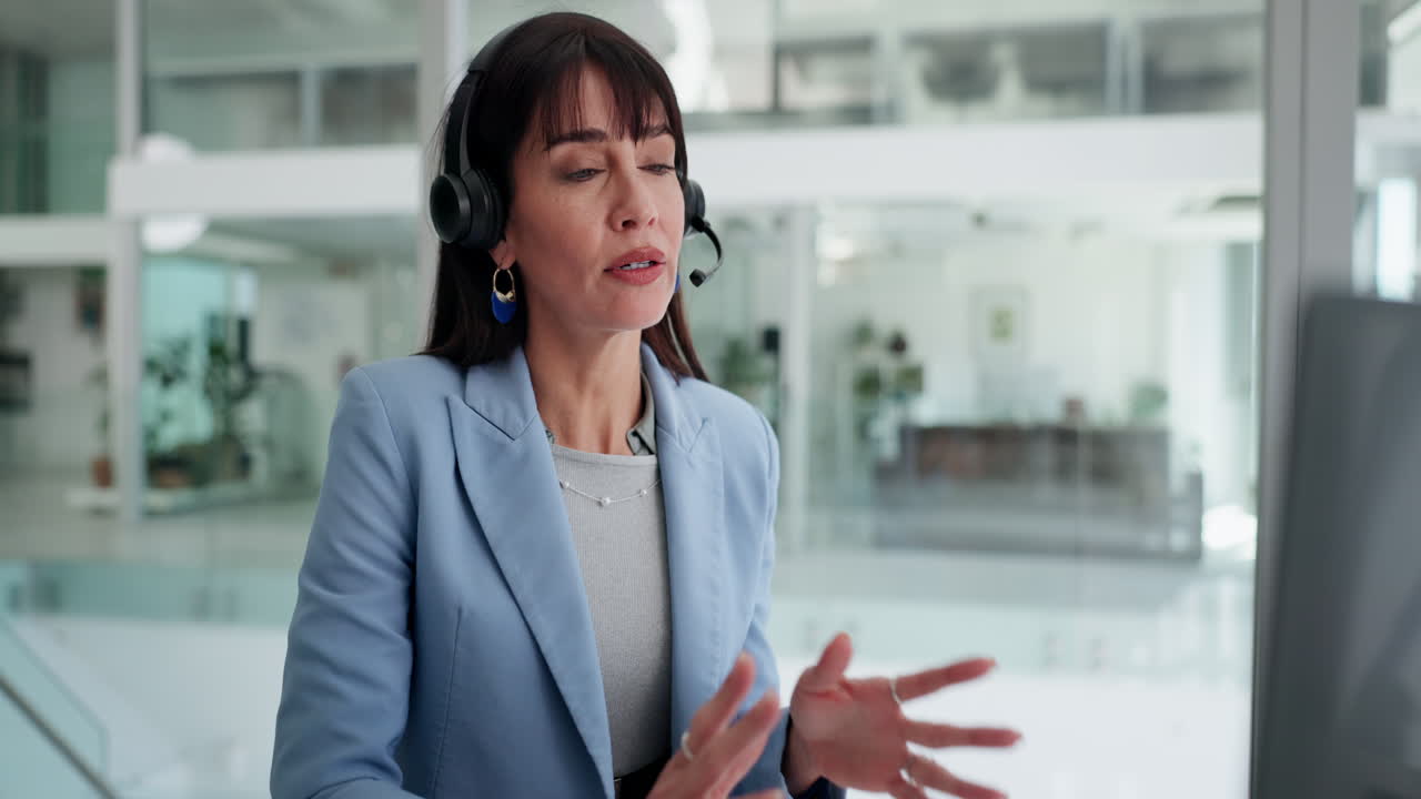 Happy Woman Wearing Headset Talking on Video Call in Modern Office