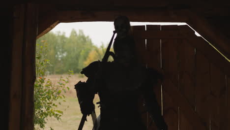 dark knight with creepy skull on helmet enters wooden gate