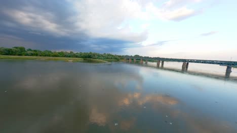 FPV-drone-shot-of-Gdanski-Bridge-built-over-Vistula-River-at-sunset,-Warsaw,-Poland