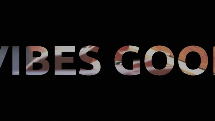 Animation of vibes text in black and white letters over child playing the piano