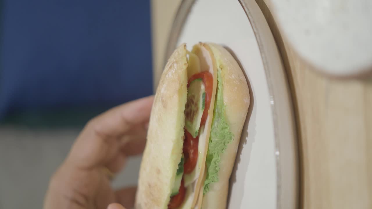 Hand holding a fresh sandwich