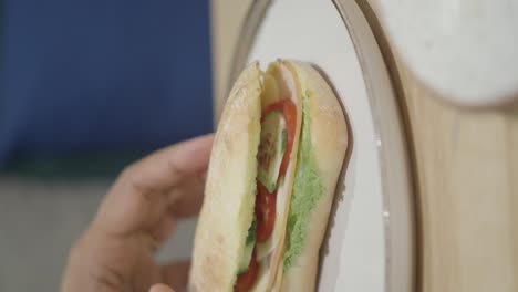 hand holding a fresh sandwich
