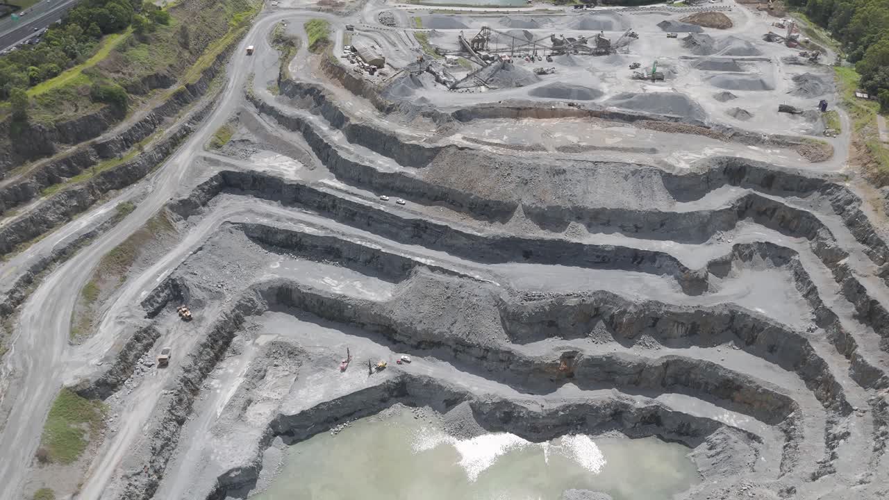 Drone captures layered quarry with water pools