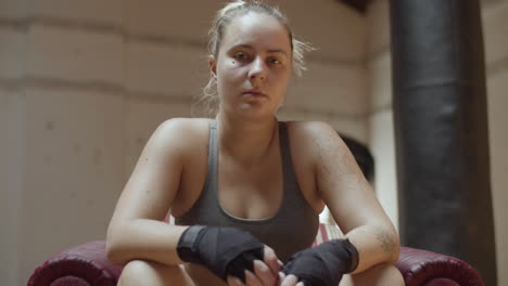 front view of confident female boxer looking at camera