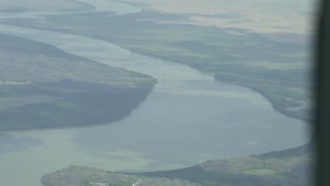 River-view-from-the-air-in-Costa-Rica-with-meandering-pathways,-Aerial-airplane-view-shot