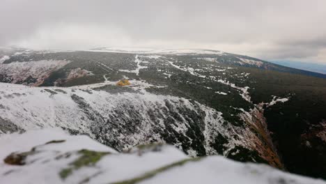 Polish-mountains,-Yellow-shelter-building,-dom-slaski,-winter-scenario