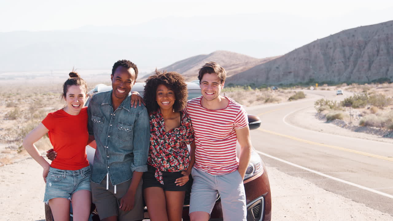 Happy friends on a road trip take a roadside break, close up
