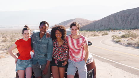 happy friends on a road trip take a roadside break, close up