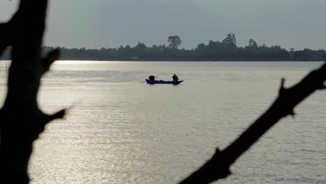 Abstract-silhouette-shot-of-a-local-Thai-fisherman-on-the-water-of-the-Chanthaburi-River,-Thailand