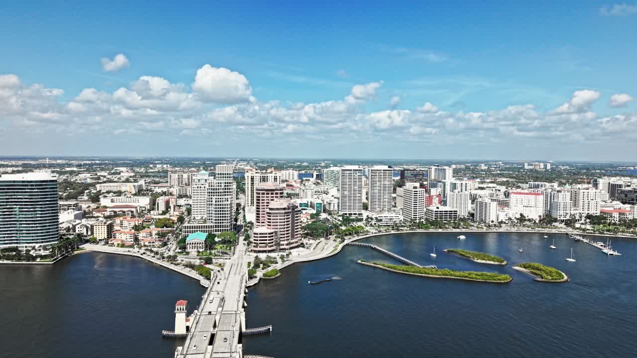 Jib up drone shot of cityscape with Royal Park Bridge, One Flagler and Phillips Point building during the day in West Palm Beach, Florida, USA