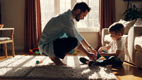 father and son tying shoes