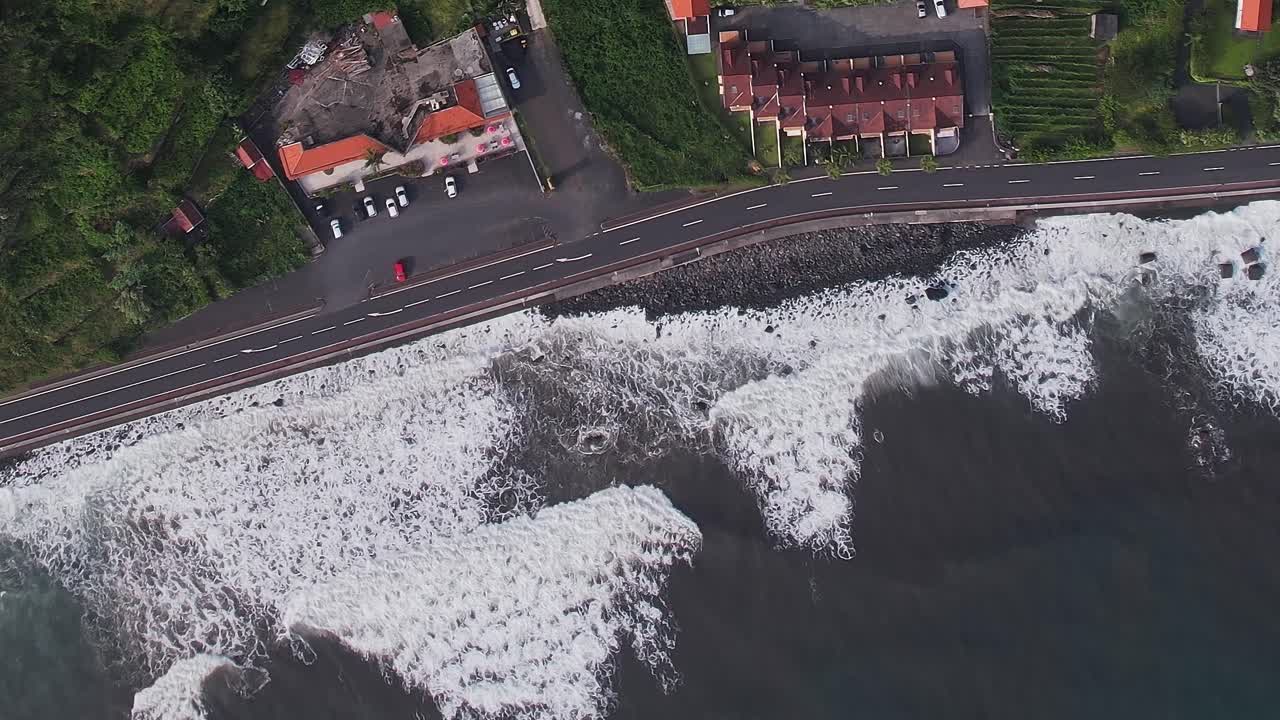 Aerial view of waves hitting coastal road in Madeira, Portugal