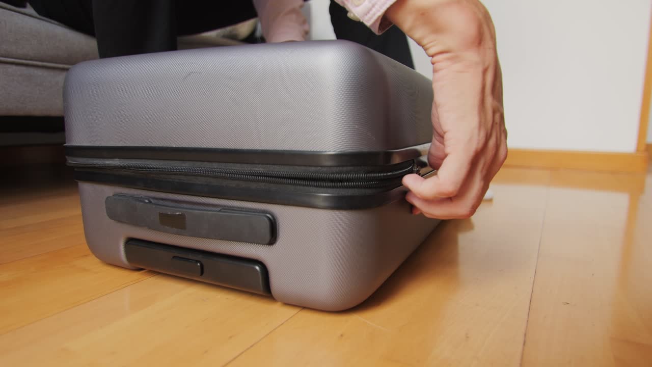 Tourism and travelling concept. Handsome business man going on holiday, packing his suitcase, checking luggage, sitting on bed and looking at packed things