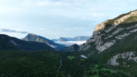 Road-leading-to-Molveno-township-through-Dolomite-mountains,-aerial-view