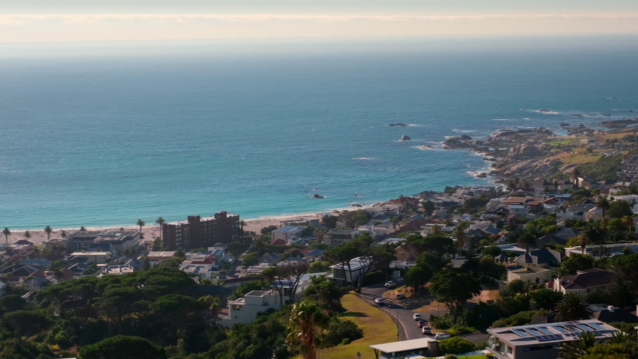 Scenic Camps Bay with white sand beach in Cape Town, vantage point pan shot