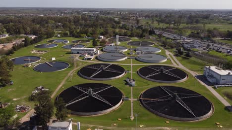 Orbit-shot-taken-of-Aysa-water-purification-plant,-one-of-the-largest-in-Buenos-Aires,-Argentina-with-highway-running-on-the-left-side-of-the-plant