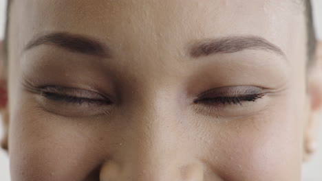 close up mixed race woman eyes making faces looking happy expression human emotion natural beauty