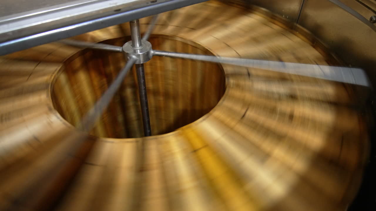 Working machine for honey extraction with frames inside. Special equipment for harvesting organic product at apiary farm.