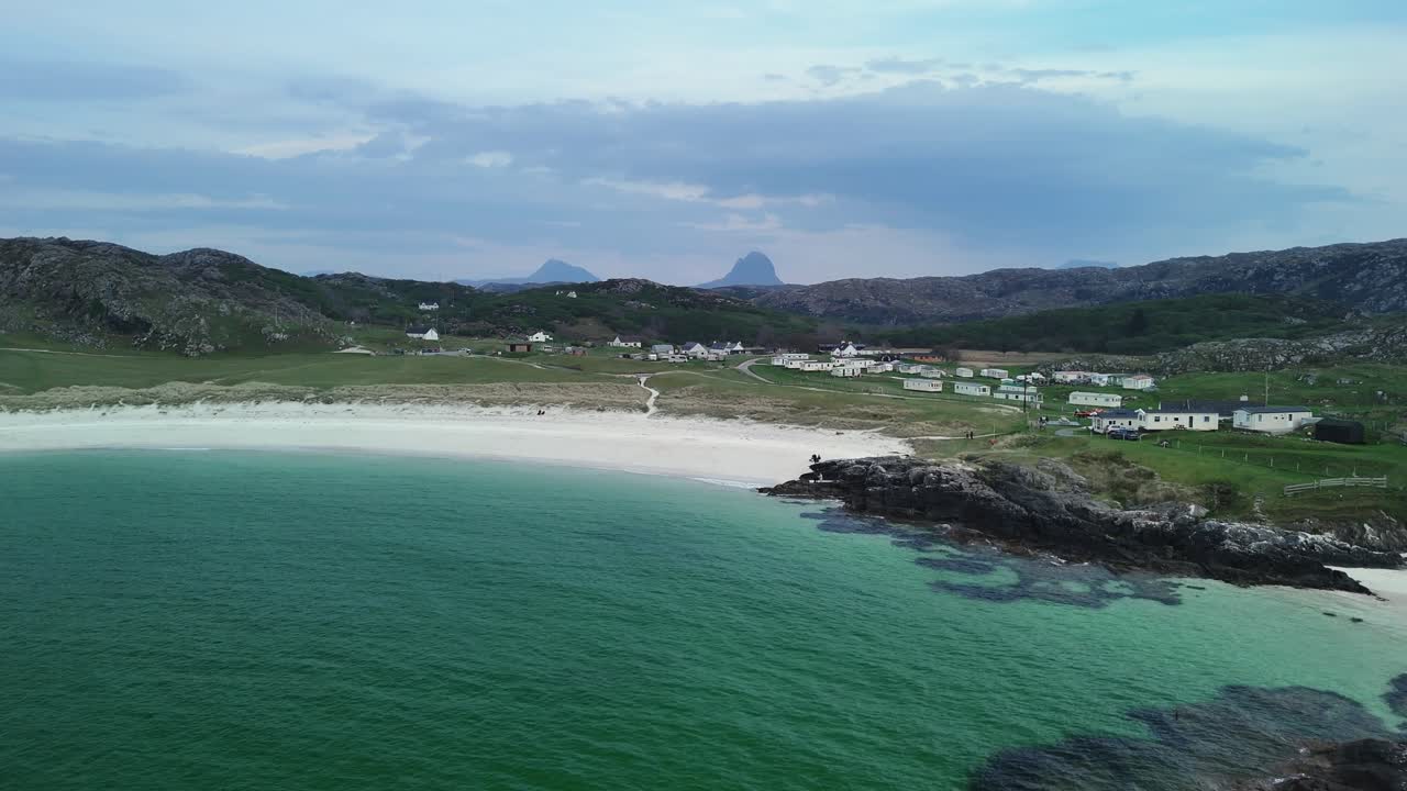 Aerial revealing shot of the beautiful coastline at Achmelvich Bay on the NC500