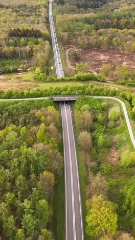 aerial view of highway and bridge through a green landscape
